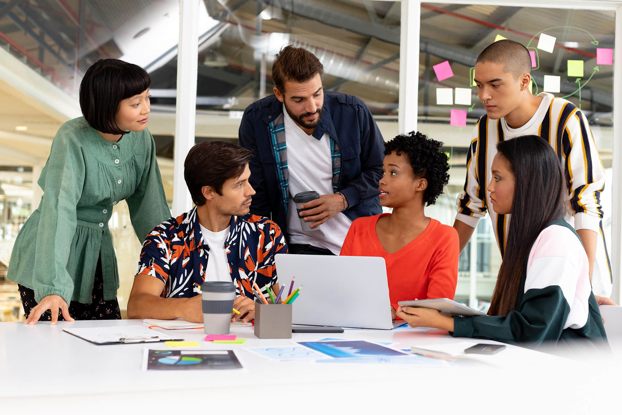 Diverse business team in front of laptop discussing their workplace harassment training